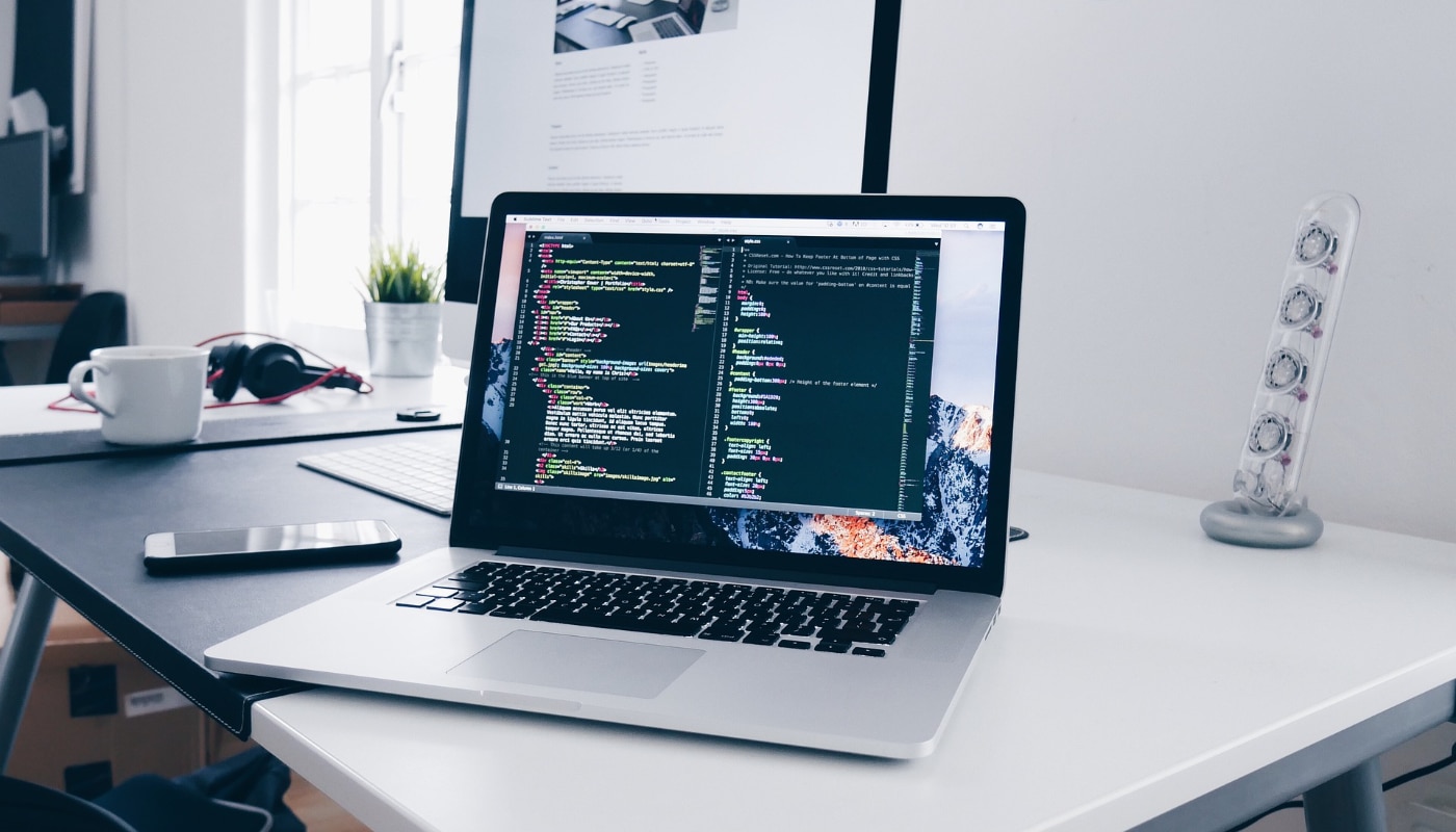 Application Support Lead header image of a laptop showing code